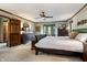 Bright primary bedroom featuring a ceiling fan, bay window, and comfortable furnishings at 160 Scranton Ct, Zionsville, IN 46077