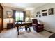 This office features a wooden desk, a comfortable armchair and a large window offering natural light and outdoor views at 160 Scranton Ct, Zionsville, IN 46077
