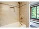 Shower featuring tiled walls, built-in niche, and window providing natural light with backyard views at 160 Scranton Ct, Zionsville, IN 46077
