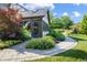 This home features a sun room with lots of windows, a stone patio, and beautiful landscaping at 160 Scranton Ct, Zionsville, IN 46077