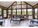 Bright sun room featuring large windows that offer views of the yard, vaulted ceiling and neutral furniture at 160 Scranton Ct, Zionsville, IN 46077