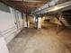 Unfinished basement featuring essential utilities, offering potential for storage or future renovations at 1601 E 44Th St, Indianapolis, IN 46205
