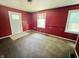 Red bedroom with a white door and windows, awaiting a makeover to restore its charm at 1601 E 44Th St, Indianapolis, IN 46205