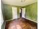 Green-toned bedroom showing access to other rooms, set to be transformed and renewed at 1601 E 44Th St, Indianapolis, IN 46205