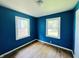 This blue bedroom with hardwood floors awaits your creative touch for a cozy transformation at 1601 E 44Th St, Indianapolis, IN 46205