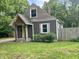 Charming bungalow with a green front door, wood porch, and landscaped yard at 1601 E 44Th St, Indianapolis, IN 46205