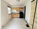 Eat-in kitchen with oak cabinets, black appliances, and tile floors at 1601 E 44Th St, Indianapolis, IN 46205
