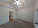 This carpeted bedroom has a double door closet, and a view into the next room at 16254 Quartz Dr, Noblesville, IN 46060
