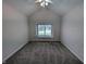 A carpeted bedroom with a window with blinds, a light fixture, and outlets at 16254 Quartz Dr, Noblesville, IN 46060
