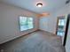 This carpeted bedroom has a double door closet, a window, and a view into the next room at 16254 Quartz Dr, Noblesville, IN 46060