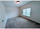 This is a view of a carpeted bedroom that has a window with blinds, and a light fixture at 16254 Quartz Dr, Noblesville, IN 46060