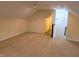 Spacious carpeted bonus room with access to stairs, perfect for a playroom or office at 16254 Quartz Dr, Noblesville, IN 46060