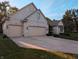 Attractive brick home with a three-car garage and well-maintained driveway, offering curb appeal at 16254 Quartz Dr, Noblesville, IN 46060
