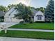 Charming brick home with a well-manicured lawn, mature trees, and a convenient two-car garage at 16254 Quartz Dr, Noblesville, IN 46060