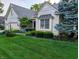 Beautiful brick home featuring lush green lawn, mature landscaping, and an inviting architectural design at 16254 Quartz Dr, Noblesville, IN 46060