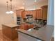 Well-equipped kitchen with stainless steel appliances, wooden cabinets, and a functional island at 16254 Quartz Dr, Noblesville, IN 46060