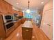 Kitchen with stainless appliances, wooden cabinets, island, and modern fixtures, perfect for cooking at 16254 Quartz Dr, Noblesville, IN 46060