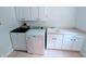 Clean laundry room equipped with white cabinetry, a sink, a washer and a dryer at 16254 Quartz Dr, Noblesville, IN 46060