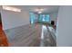 Bright, open-plan living room with a ceiling fan, fireplace, large windows and plush neutral carpet at 16254 Quartz Dr, Noblesville, IN 46060