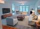 Bright living room with large windows, fireplace, ceiling fan, and stylish modern furniture at 16254 Quartz Dr, Noblesville, IN 46060