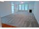 Spacious living room with natural light, plush carpet, fireplace, and views to the outdoors at 16254 Quartz Dr, Noblesville, IN 46060