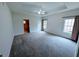 Expansive main bedroom with tray ceiling, plush carpeting, and windows providing natural light at 16254 Quartz Dr, Noblesville, IN 46060