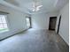 Spacious main bedroom featuring a tray ceiling, neutral carpeting, and windows providing natural light at 16254 Quartz Dr, Noblesville, IN 46060