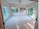 Bright sunroom filled with natural light from multiple windows and a sliding glass door to the outdoors at 16254 Quartz Dr, Noblesville, IN 46060