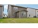 The backyard features green grass and a view of the home's gray siding and neutral trim at 1911 Goodwin Pl, Westfield, IN 46074