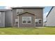 The backyard features green grass and a view of the home's gray siding and neutral trim at 1911 Goodwin Pl, Westfield, IN 46074