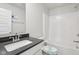 Bright bathroom featuring a vanity with dark countertop, toilet, and tub/shower combination at 1911 Goodwin Pl, Westfield, IN 46074