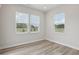 Bright bedroom with wood-look floors, neutral paint, and large windows at 1911 Goodwin Pl, Westfield, IN 46074