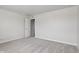 This bedroom has neutral paint and carpet, an open closet, and a window for plenty of light at 1911 Goodwin Pl, Westfield, IN 46074