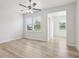 Bright bedroom with natural lighting from two large windows, ceiling fan and natural wood floors at 1911 Goodwin Pl, Westfield, IN 46074