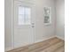 Bright entryway with decorative glass front door, natural wood flooring, and white trim at 1911 Goodwin Pl, Westfield, IN 46074