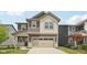 Two-story home with brown and beige siding, an attached two car garage, and covered front porch at 1911 Goodwin Pl, Westfield, IN 46074