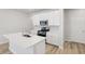 Bright kitchen with white cabinets, stainless steel appliances, island with sink and oven with gas range at 1911 Goodwin Pl, Westfield, IN 46074