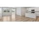 Open concept living room and kitchen with white walls, ceiling fan, and large windows at 1911 Goodwin Pl, Westfield, IN 46074