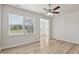 Bright living room featuring wood-look flooring, large windows, and ceiling fan at 1911 Goodwin Pl, Westfield, IN 46074