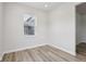 Neutral room featuring wood-look floors and a window with natural light at 1911 Goodwin Pl, Westfield, IN 46074