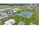 Aerial view highlighting a community pool, tennis courts, pond, and clubhouse in a well-planned neighborhood at 19959 Cowie Ln, Westfield, IN 46074