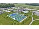 Overhead shot displaying community tennis courts, pool, clubhouse, pond, and walking path, enhancing the lifestyle at 19959 Cowie Ln, Westfield, IN 46074