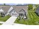 Aerial view of a well-maintained home with a two-car garage, a covered porch and landscaped front yard at 19959 Cowie Ln, Westfield, IN 46074