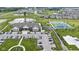 Aerial view showcases a community center, tennis courts, pond, and green spaces in a residential development at 19959 Cowie Ln, Westfield, IN 46074