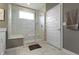 Bright bathroom featuring a glass enclosed shower with built-in seat and marble surround at 19959 Cowie Ln, Westfield, IN 46074
