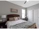 A neutral bedroom features a ceiling fan, picture window, and sliding door closet at 19959 Cowie Ln, Westfield, IN 46074