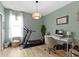 A bedroom featuring a treadmill, desk, ceiling light and wood-look floors at 19959 Cowie Ln, Westfield, IN 46074