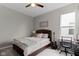 A neutral bedroom features a ceiling fan, picture window, and desk with chair at 19959 Cowie Ln, Westfield, IN 46074