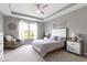Bright bedroom featuring a ceiling fan, neutral walls, tray ceiling, a window with natural light, and carpeted floors at 19959 Cowie Ln, Westfield, IN 46074