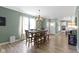 Dining room features dark wood table with chair set, chandelier lighting and hardwood floors at 19959 Cowie Ln, Westfield, IN 46074